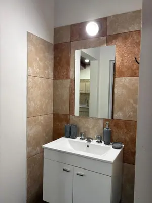 a bathroom with a white sink and a mirror at Dos Osos in Villa General Belgrano