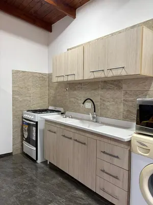a kitchen with a sink and a stove at Dos Osos in Villa General Belgrano