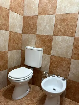 a bathroom with a toilet and a sink at Dos Osos in Villa General Belgrano