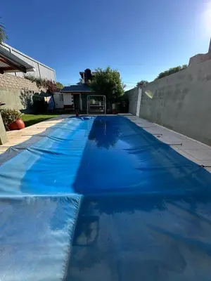 a large blue swimming pool in a backyard at Sierra Chica in Alta Gracia