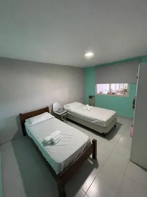 two beds in a room with green walls at Sierra Chica in Alta Gracia