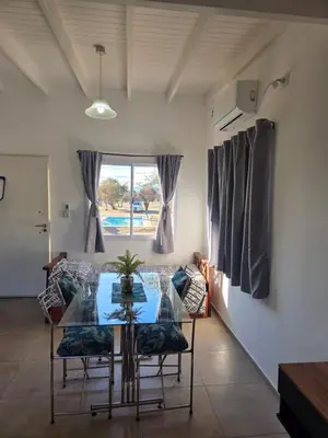 a dining room with a glass table and chairs at La Jocunda - Cortaderas - Piscu Yaco in Cortaderas
