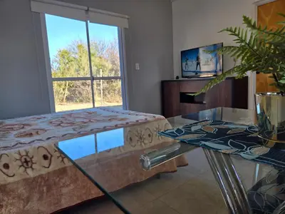 a living room with a couch and a glass table at La Jocunda - Cortaderas - Piscu Yaco in Cortaderas