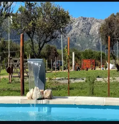 a pool with a water fountain in a park at La Jocunda - Cortaderas - Piscu Yaco in Cortaderas