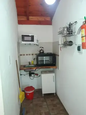 a small kitchen with a microwave and a counter at Lomas de Belgrano in Villa General Belgrano
