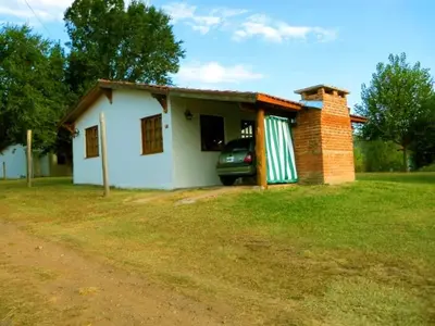 a small house with a car parked in front of it at Lomas de Belgrano in Villa General Belgrano