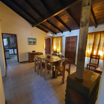 a dining room with a table and chairs at El Cartucho in Villa General Belgrano