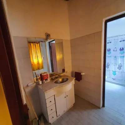 a bathroom with a sink and a mirror at El Cartucho in Villa General Belgrano