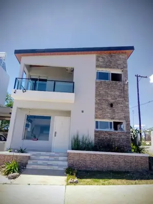 a white brick house with a balcony on top at Encanto Serrano II in Villa Carlos Paz