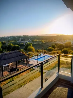 a view from the balcony of a house with a swimming pool at Encanto Serrano II in Villa Carlos Paz