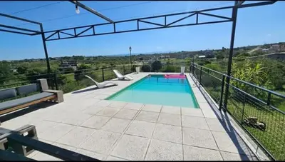 a swimming pool with a fence around it at Encanto Serrano II in Villa Carlos Paz