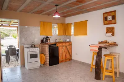 a kitchen with a stove and a refrigerator at Aires de Paz in Las Calles