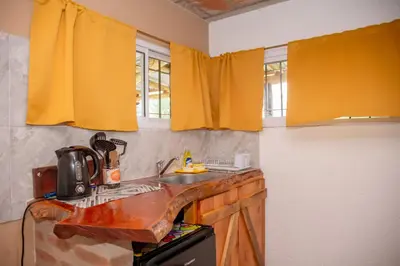 a kitchen with yellow curtains and a sink at Aires de Paz in Las Calles
