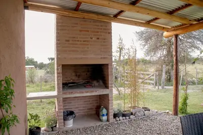 a brick fireplace in a patio with a roof at Aires de Paz in Las Calles