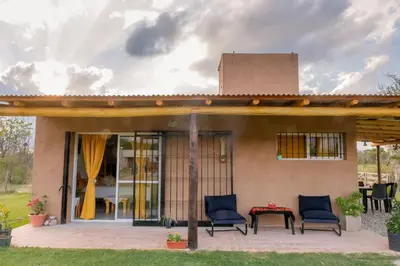 a house with two chairs and a table on a patio at Aires de Paz in Las Calles