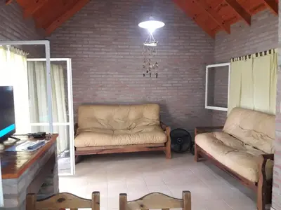 a living room with two couches and a table at Mis tres estrellas in Villa Los Aromos