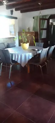 a dining room table with chairs and a plant on it at Casa on the rock's in Nono