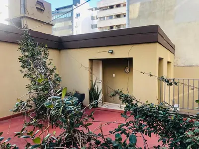 a building with a door in the side of it at Departamento con cochera terraza y asador in Cordoba