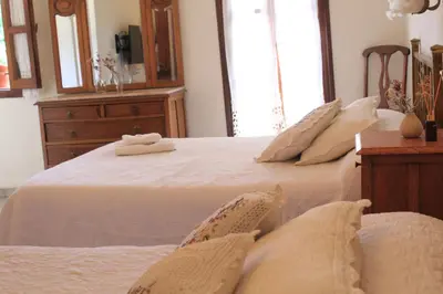 a bedroom with a bed with white sheets and pillows at Alta Gracia Hotel Boutique in Alta Gracia