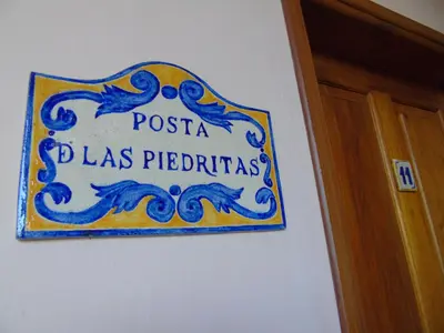 a sign on a wall next to a door at Alta Gracia Hotel Boutique in Alta Gracia