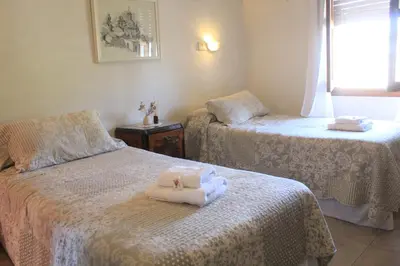 a room with two beds with towels on them at Alta Gracia Hotel Boutique in Alta Gracia