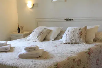 a bedroom with a bed with towels on it at Alta Gracia Hotel Boutique in Alta Gracia