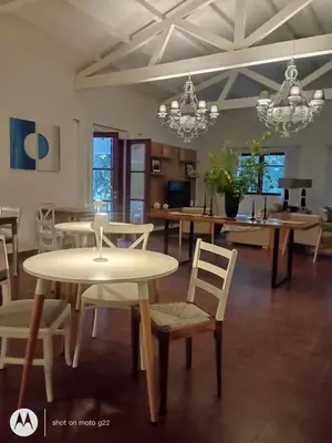 a dining room with tables and chairs in a room at Madaro House in San Antonio de Arredondo