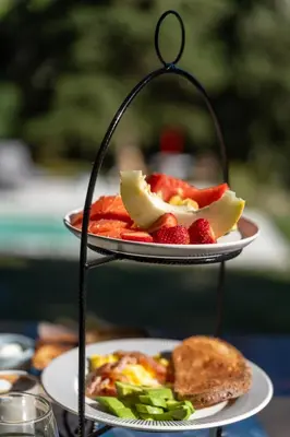 two plates of food on a table with fruit at Madaro House in San Antonio de Arredondo