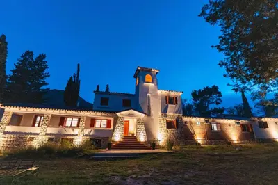 a large building with lights on it at night at Madaro House in San Antonio de Arredondo