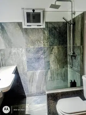 a bathroom with a shower and a toilet and a sink at Madaro House in San Antonio de Arredondo