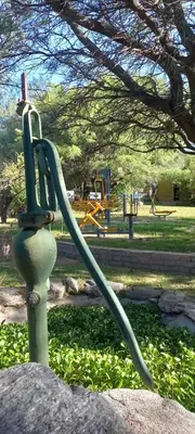 a hose hooked up to a rock in a park at Complejo Pasos Malos in Merlo