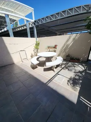 a picnic table and a bench in a patio at Departamento Champaqui in Villa Carlos Paz