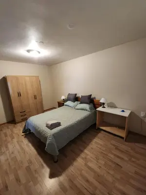a bedroom with a bed and a desk in it at Departamento Champaqui in Villa Carlos Paz