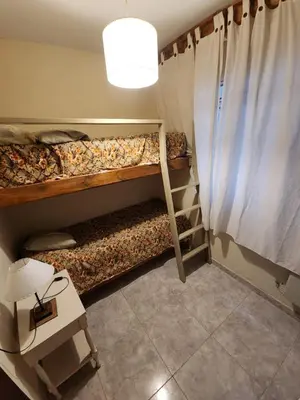 a room with two bunk beds with a light at Departamento Champaqui in Villa Carlos Paz