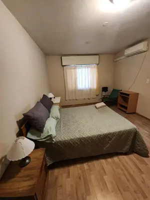 a bedroom with a large bed and a window at Departamento Champaqui in Villa Carlos Paz
