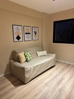 a couch in a living room with pictures on the wall at Central & Comfy Apt in Córdoba in Cordoba