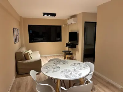 a living room with a white table and chairs at Central & Comfy Apt in Córdoba in Cordoba