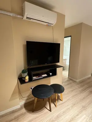 a living room with a table and a flat screen tv at Central & Comfy Apt in Córdoba in Cordoba
