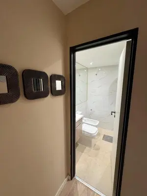 a bathroom with a toilet and a sliding glass door at Central & Comfy Apt in Córdoba in Cordoba