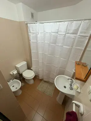 a bathroom with a toilet and a bidet and a sink at Bv Illia - 1 dormitorio Bº Nueva Córdoba in Cordoba