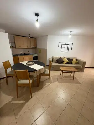 a living room with a table and a couch at Bv Illia - 1 dormitorio Bº Nueva Córdoba in Cordoba