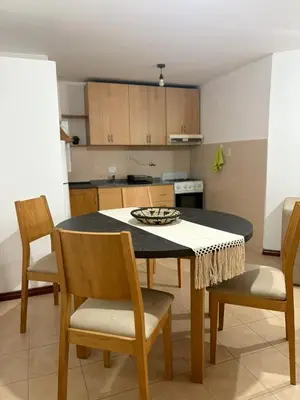 a kitchen with a table and chairs in a room at Bv Illia - 1 dormitorio Bº Nueva Córdoba in Cordoba