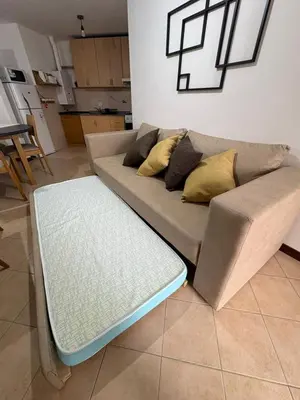 a couch with pillows on it in a living room at Bv Illia - 1 dormitorio Bº Nueva Córdoba in Cordoba