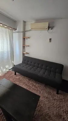 a black couch sitting in a living room at Elegante Depto 1 dorm pleno centro! in Cordoba