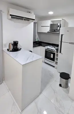 a white kitchen with a refrigerator and a microwave at apartamento in Cordoba
