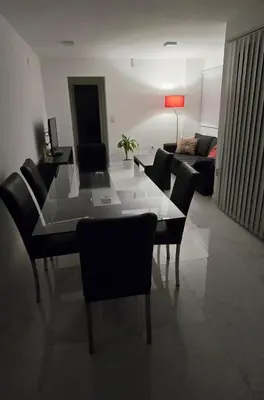 a living room with a glass table and chairs at apartamento in Cordoba