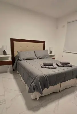 a bedroom with a large bed with two pillows on it at apartamento in Cordoba