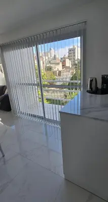 a kitchen with a large window with a view of a city at apartamento in Cordoba