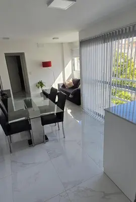 a living room with a glass table and chairs at apartamento in Cordoba