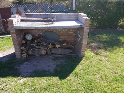 a brick oven with a pile of wood in it at Wikam in Cordoba